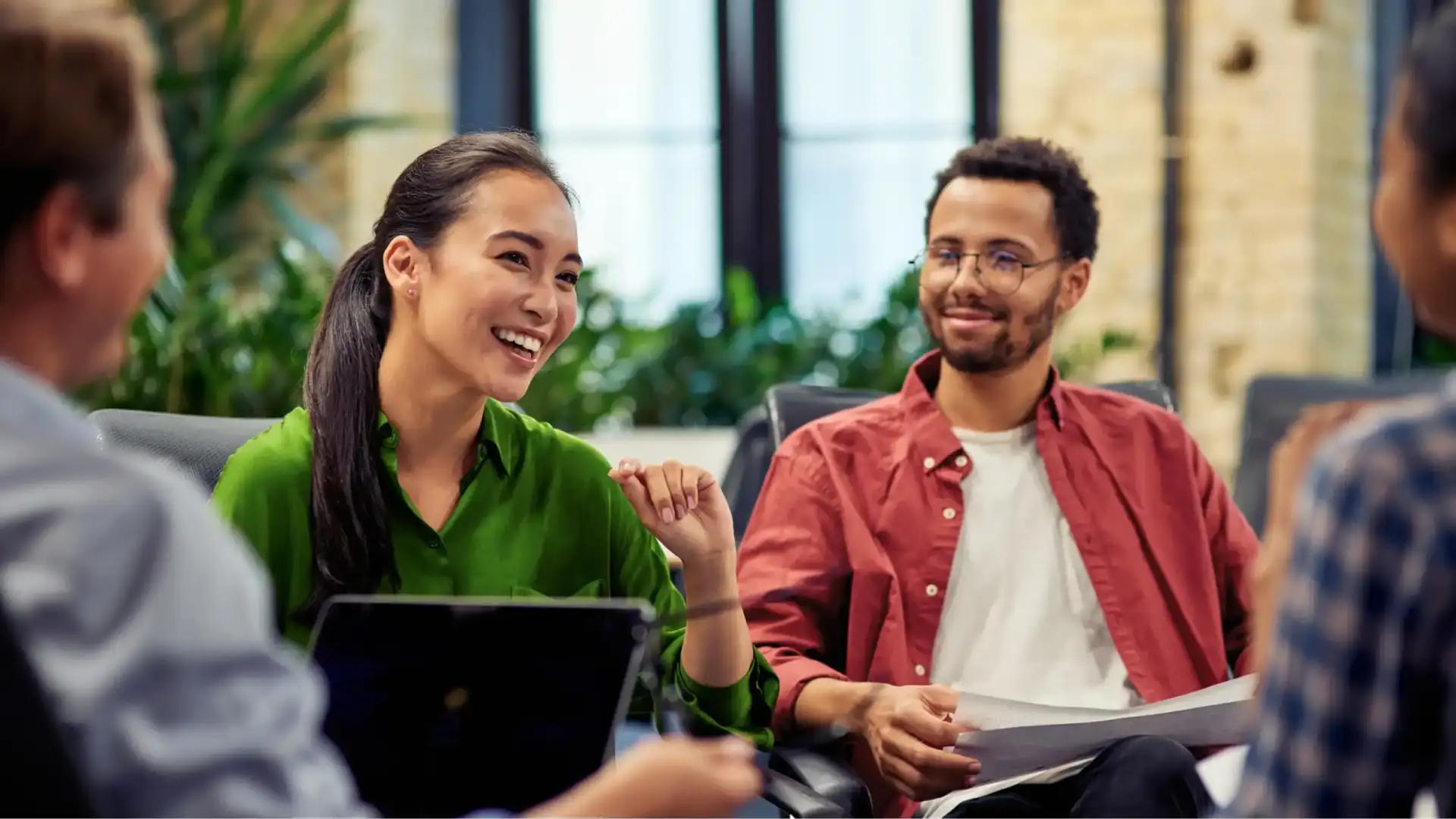 Small group sitting together in a casual meeting, smiling and talking, suggesting shared clarity, discussion, and intentional direction.